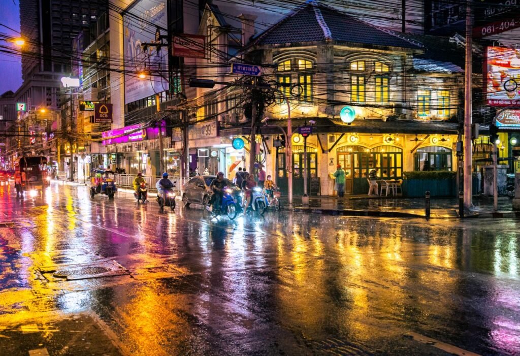 Crafting Captivating Headlines: Your awesome post title goes here Explore the vibrant nightlife of Bangkok on a rainy evening, with bustling streets and neon lights reflecting in water.