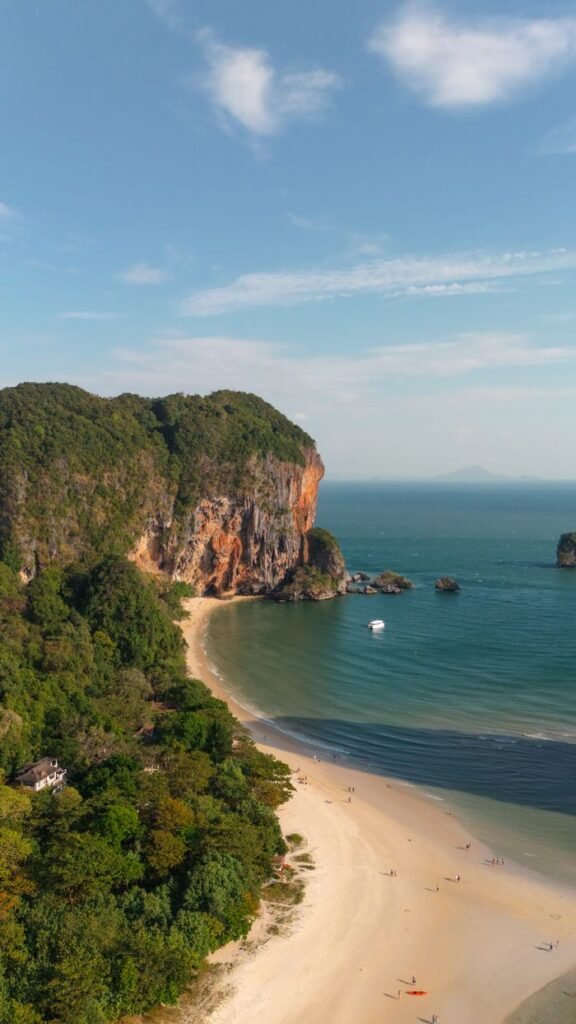 Breathtaking aerial view of Ao Nang Beach, Krabi with cliffs and the Andaman Sea.